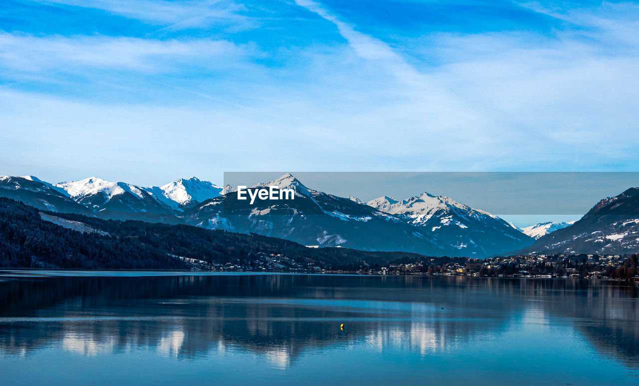 SCENIC VIEW OF LAKE AND SNOWCAPPED MOUNTAINS AGAINST SKY DURING WINTER