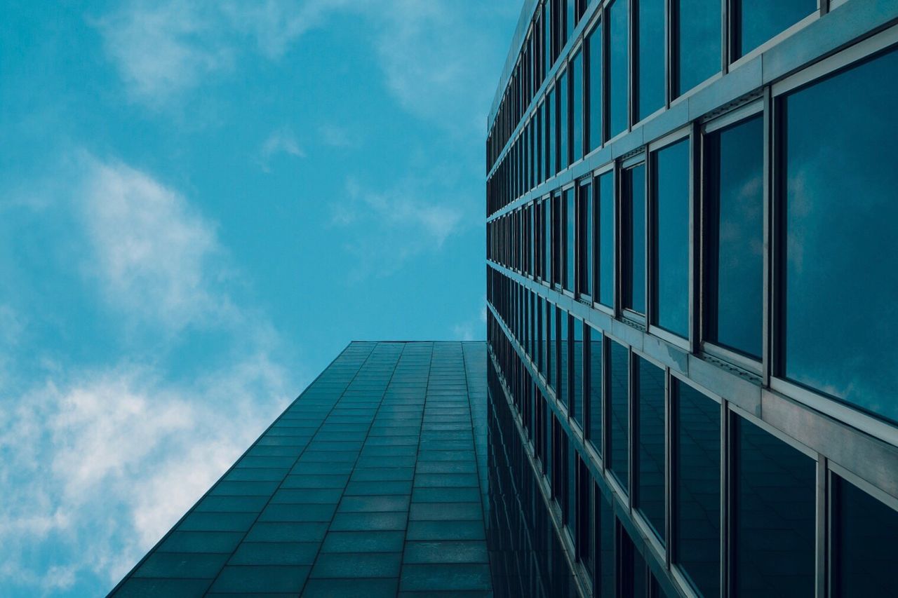 Directly below shot of office building against sky