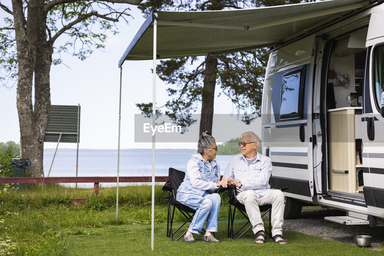 Senior couple camping by sea