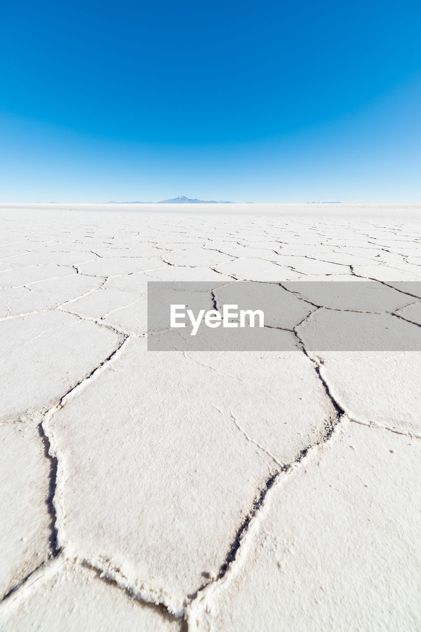 Scenic view of desert against blue sky