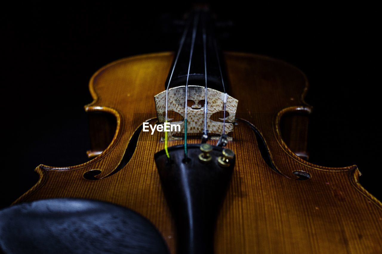 Close-up of violin against black background