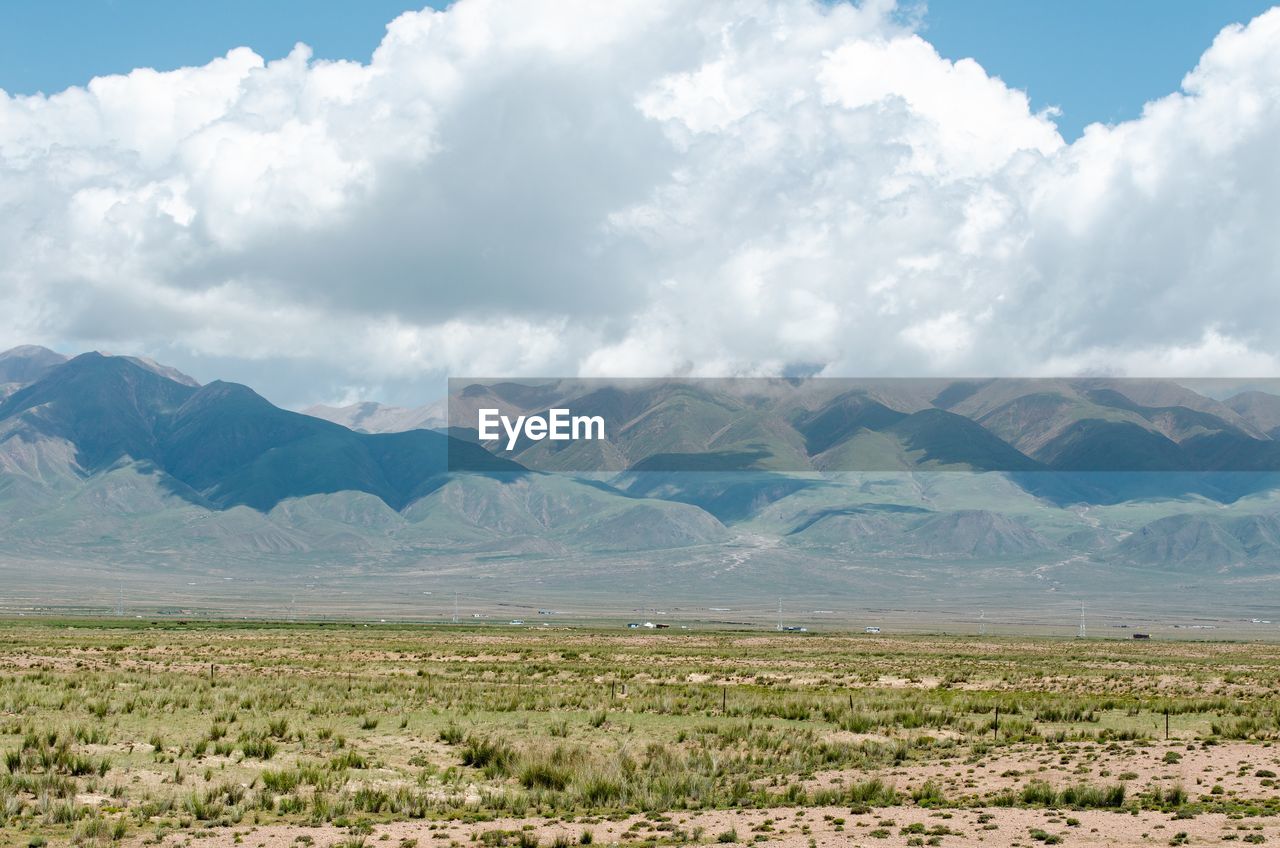 SCENIC VIEW OF FIELD AND MOUNTAINS AGAINST SKY