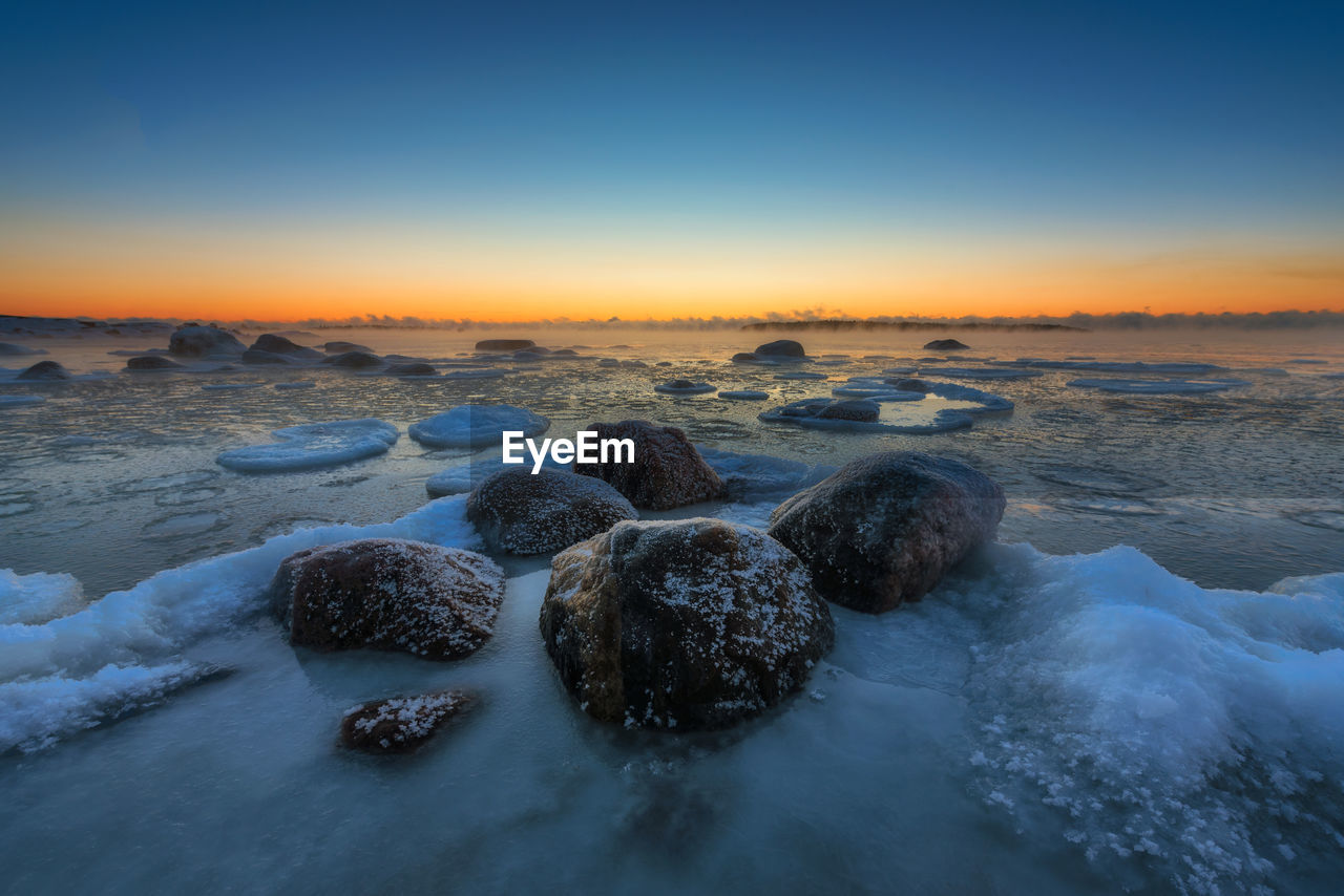 Scenic view of sea against clear sky during winter