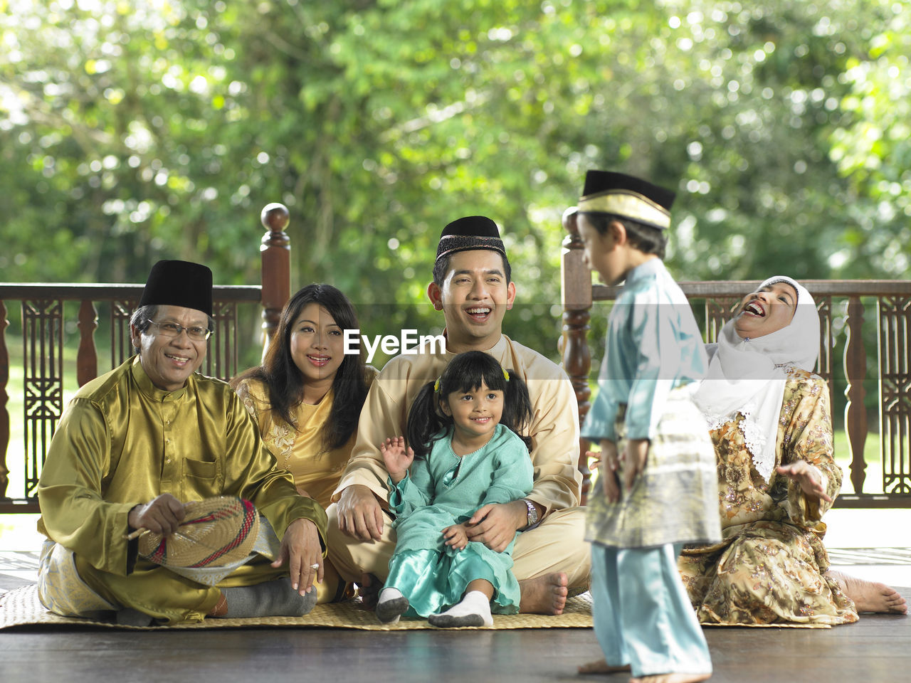 Family sitting in gazebo during traditional festival