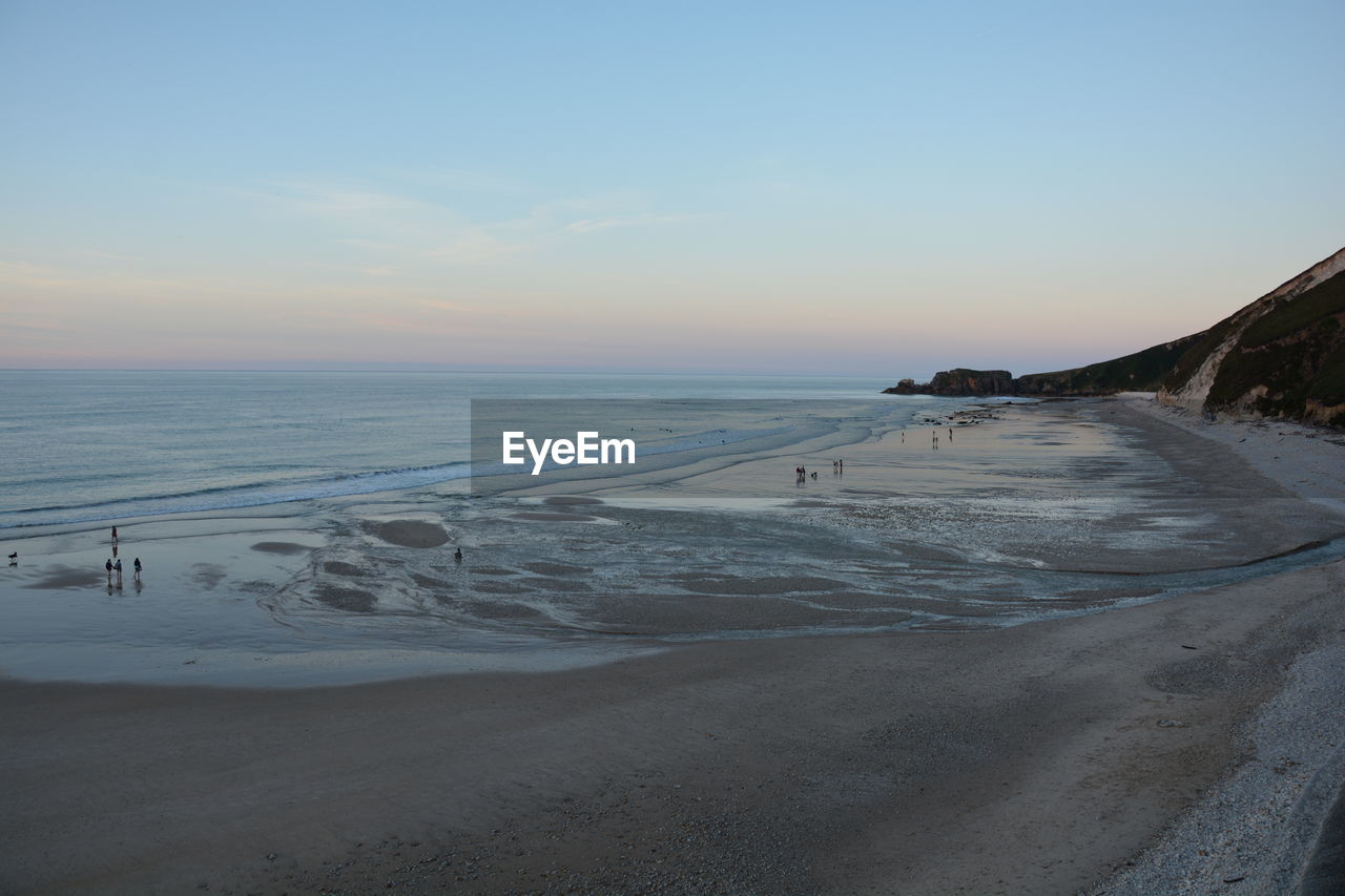 SCENIC VIEW OF SEA AGAINST SKY AT SUNSET