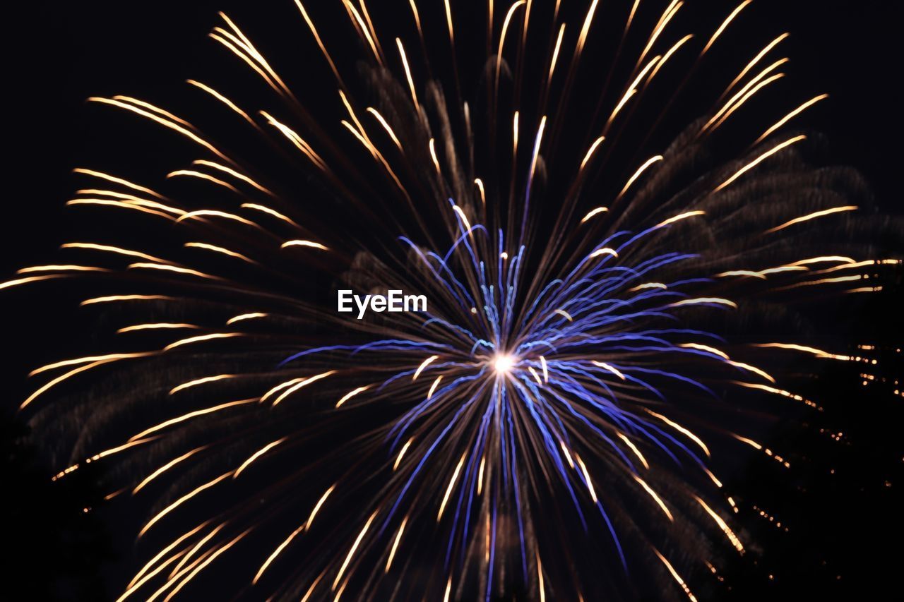 LOW ANGLE VIEW OF FIREWORKS IN SKY