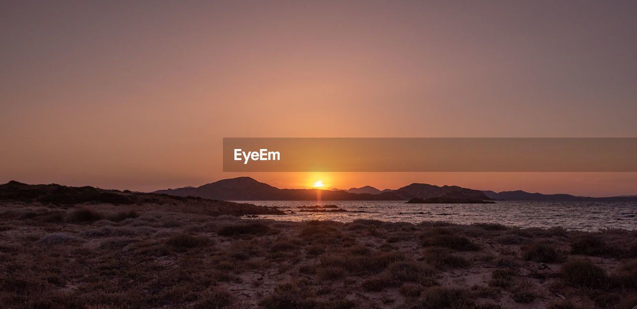 SCENIC VIEW OF SEA AGAINST ORANGE SKY