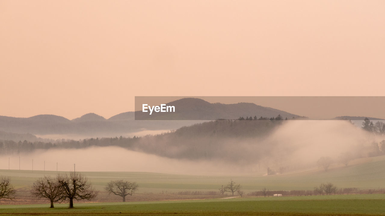 Scenic view of field against sky during sunset