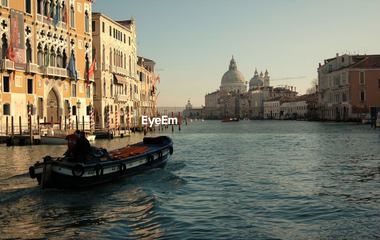 BOATS IN CANAL AGAINST CLEAR SKY