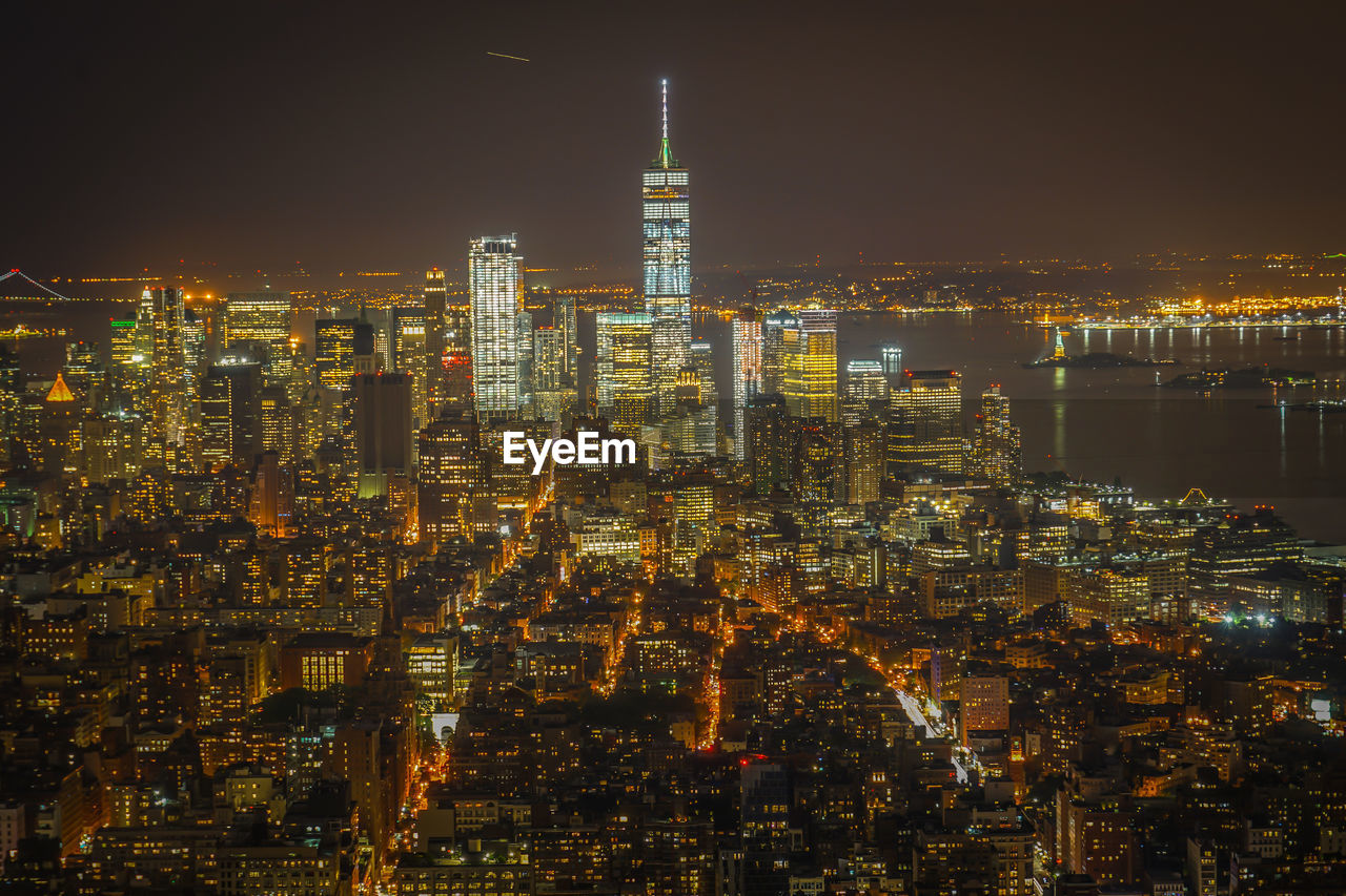 high angle view of illuminated cityscape against sky at night