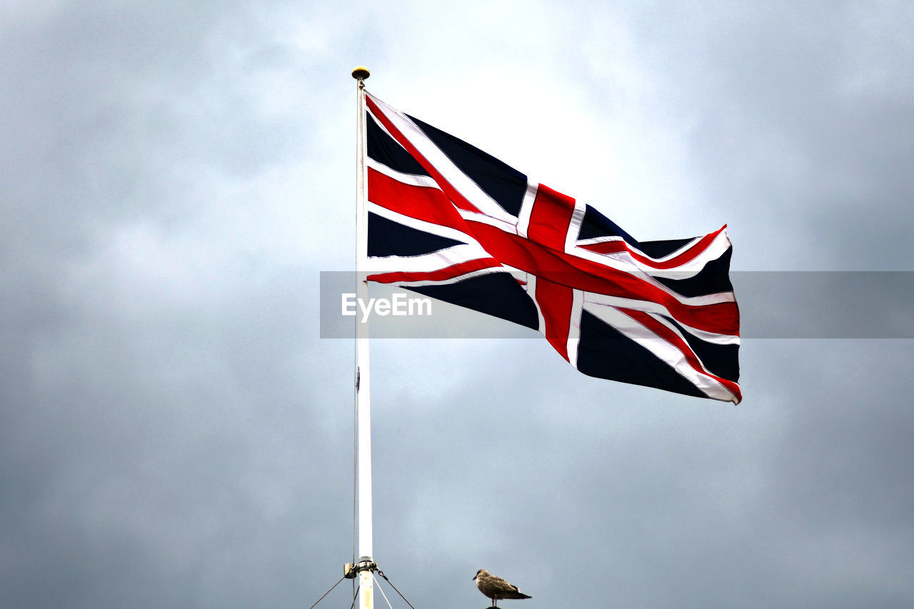 Low angle view of british flag against sky