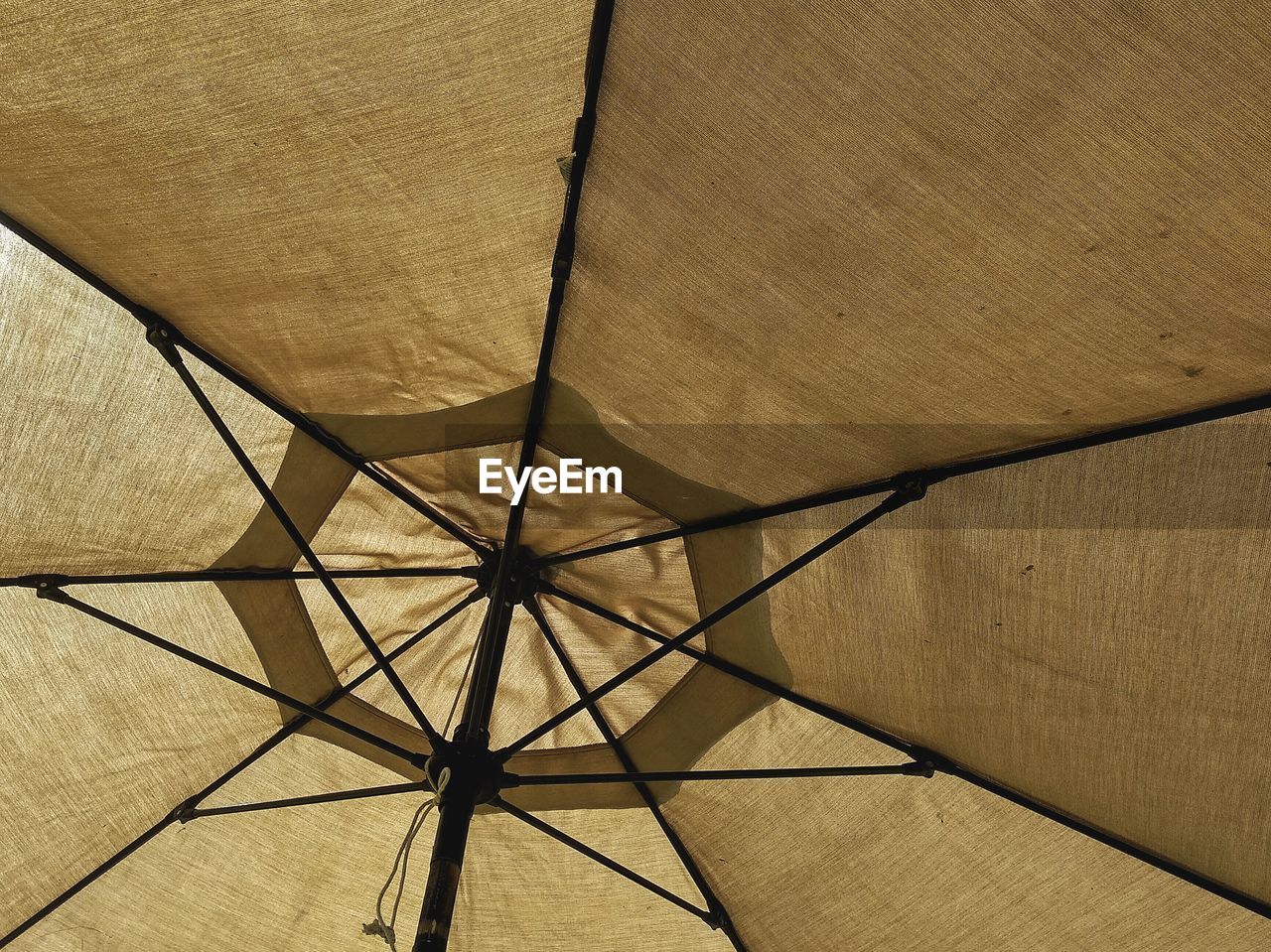 Low angle view of beige umbrella