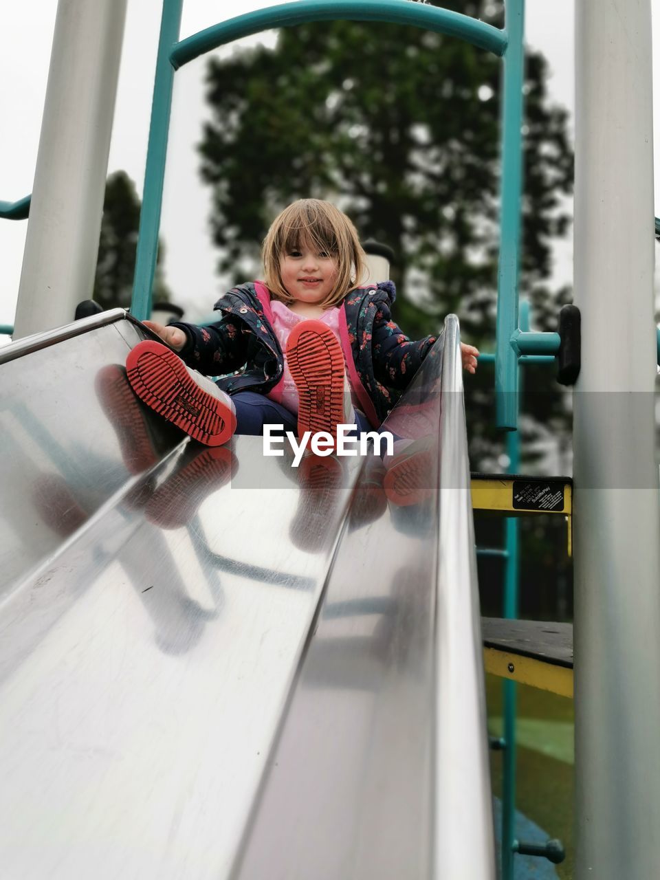 Portrait of girl playing in glass window