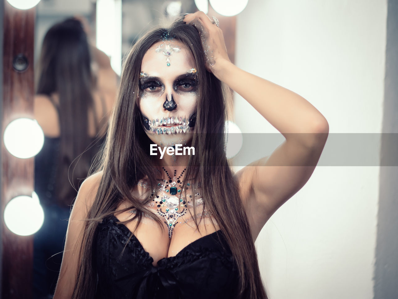 Close-up portrait of young woman with spooky face paint