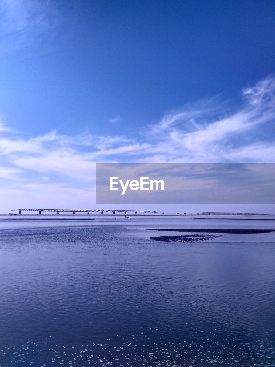 Scenic view of sea against blue sky