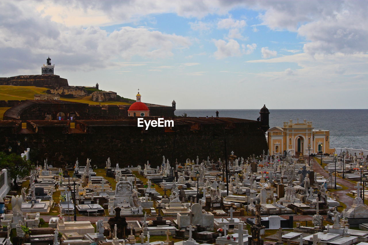 El morro castle and san juan cemetery against cloudy sky