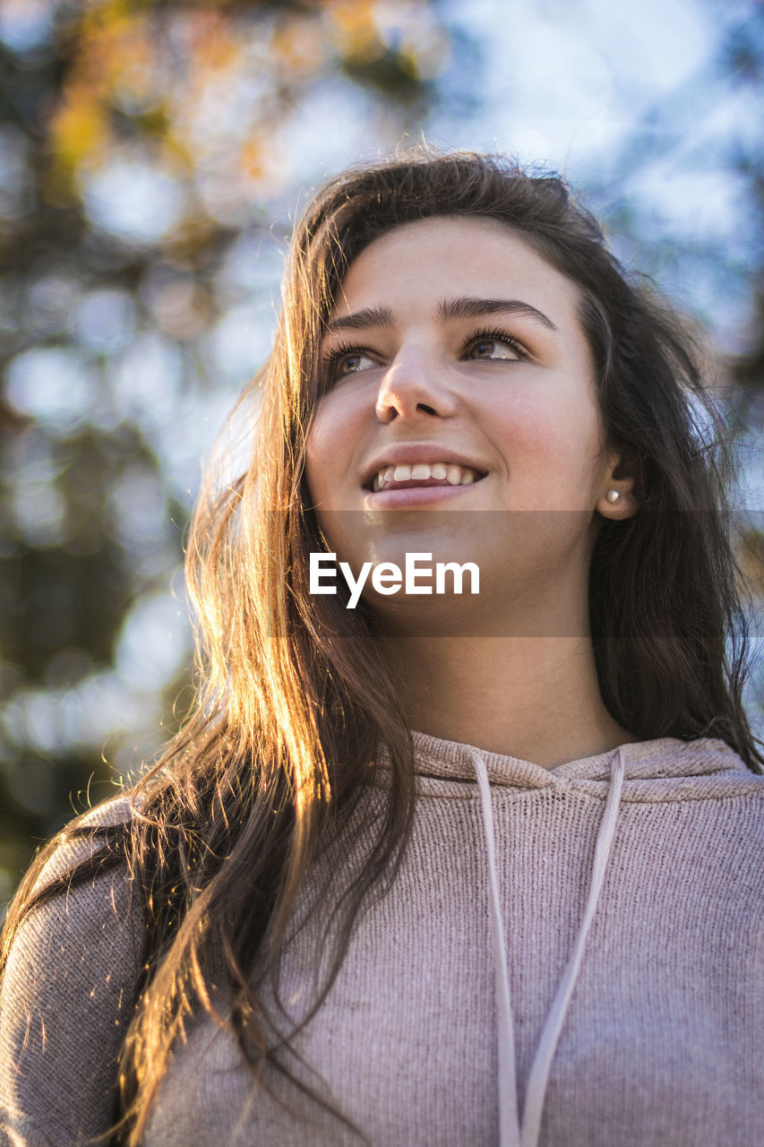Portrait of smiling young woman looking away