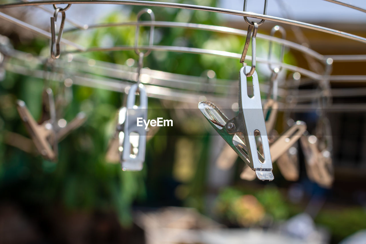 Close-up of clothespins hanging on clothesline
