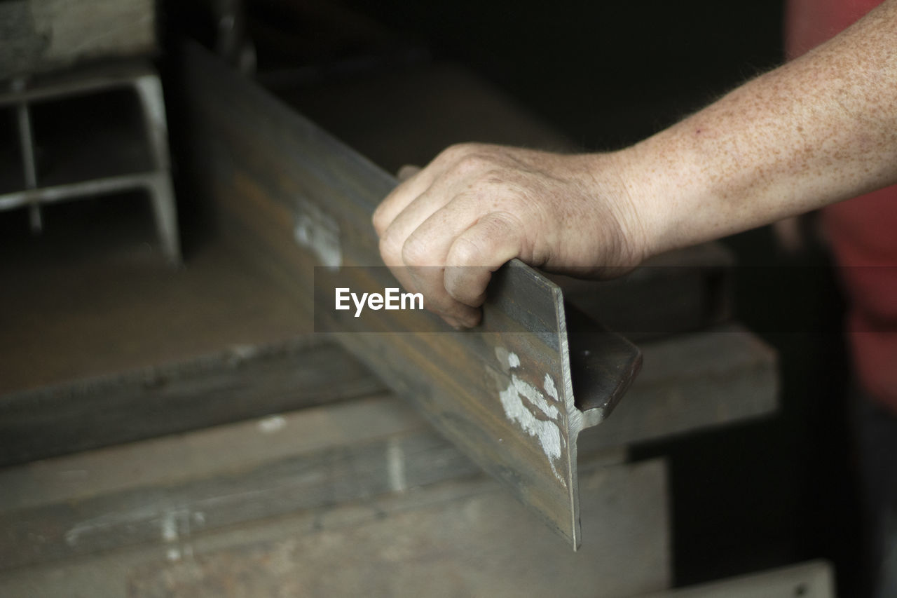 cropped hands of man working at home