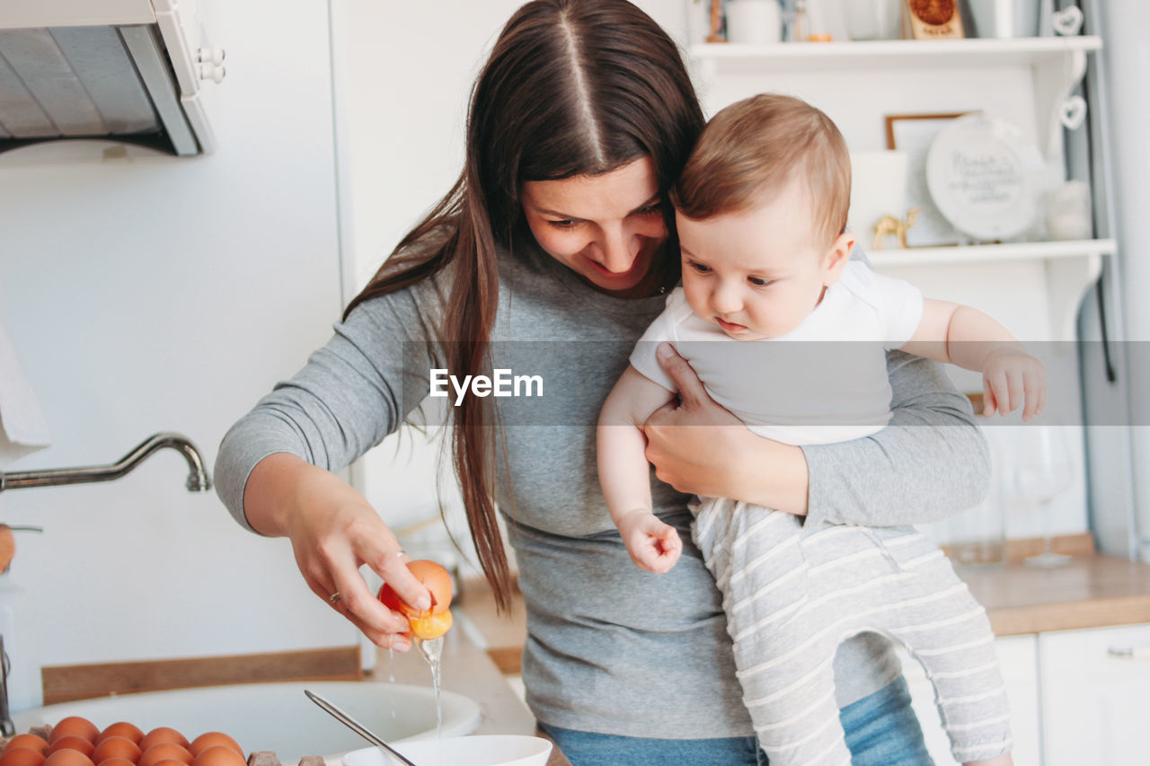 Mother with son preparing at home