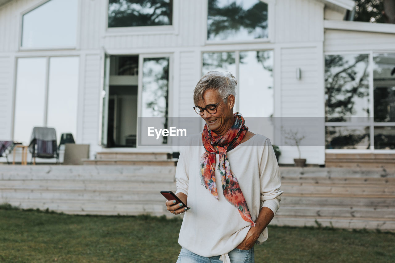 Smiling woman using cell phone