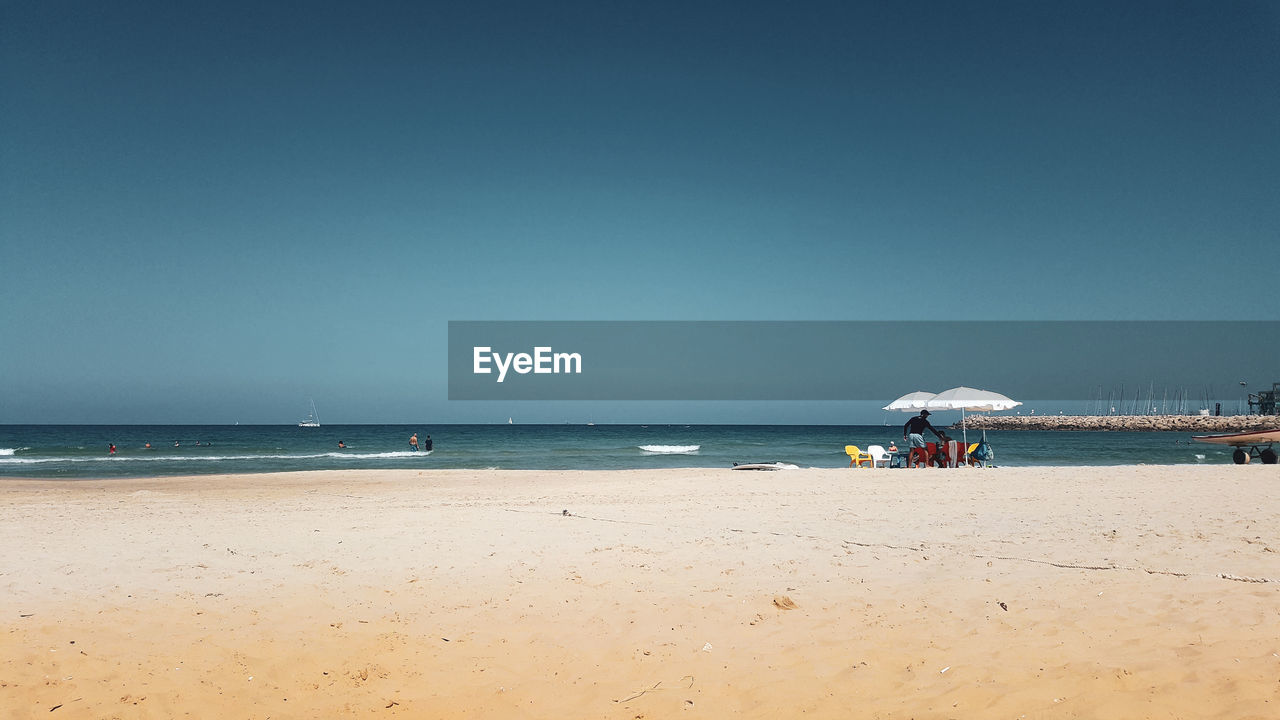 Scenic view of beach against clear sky