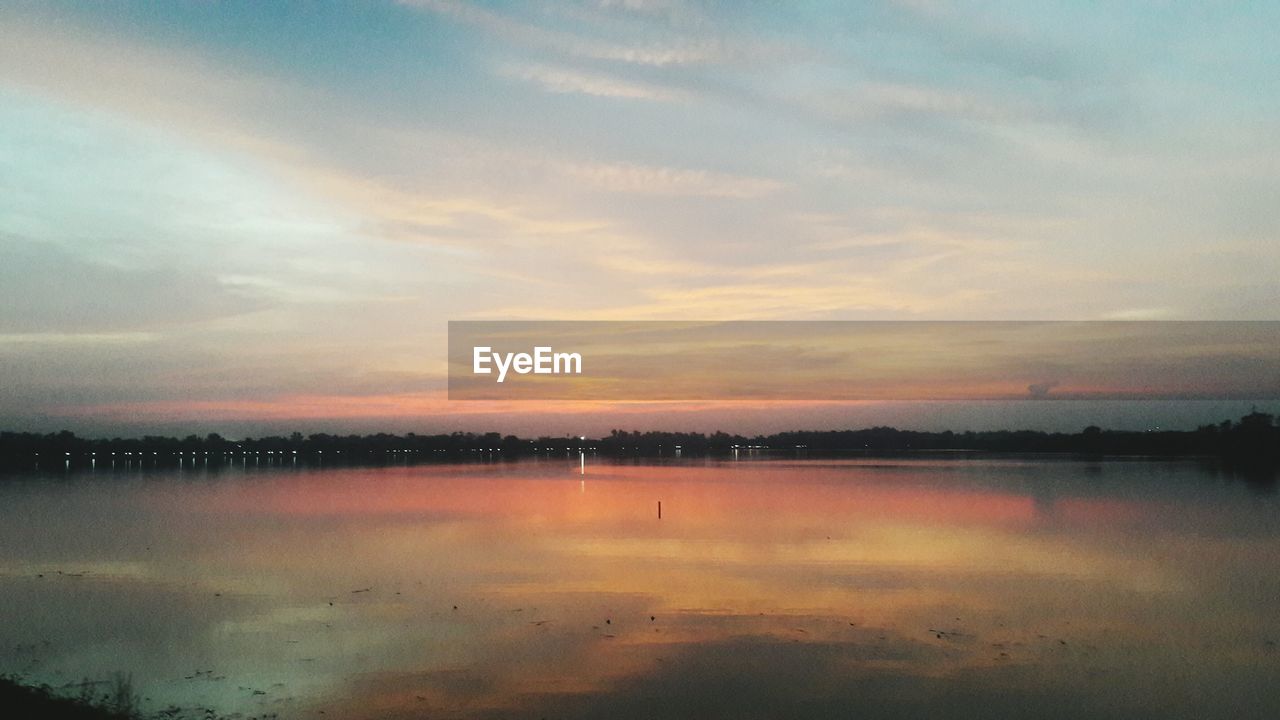 VIEW OF LAKE AGAINST SKY DURING SUNSET