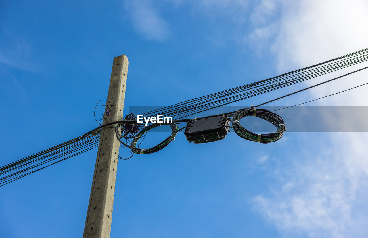 Low angle view of electricity pylon against sky