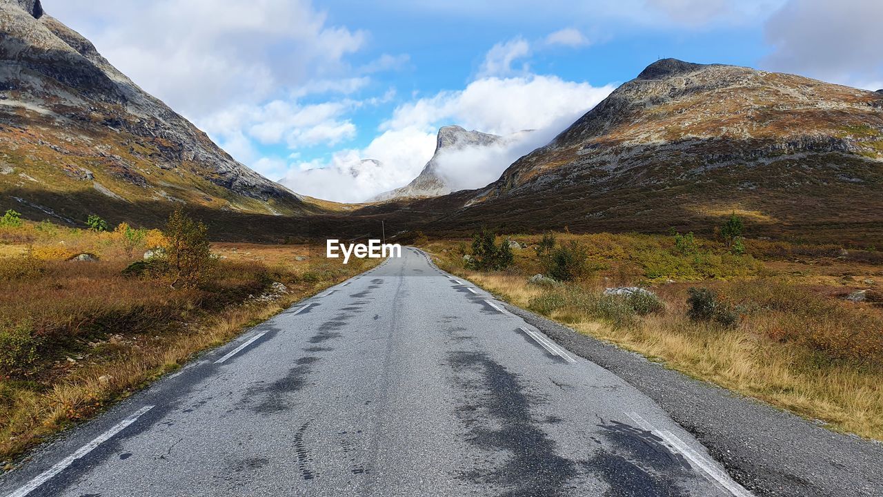 Road amidst mountains against sky