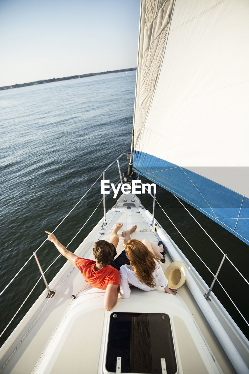 High angle view of couple sitting in yacht