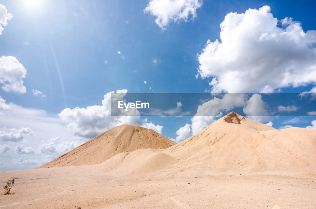 View of desert against cloudy sky
