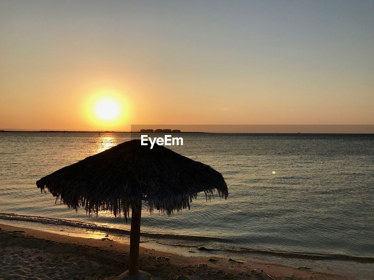 SCENIC VIEW OF BEACH DURING SUNSET