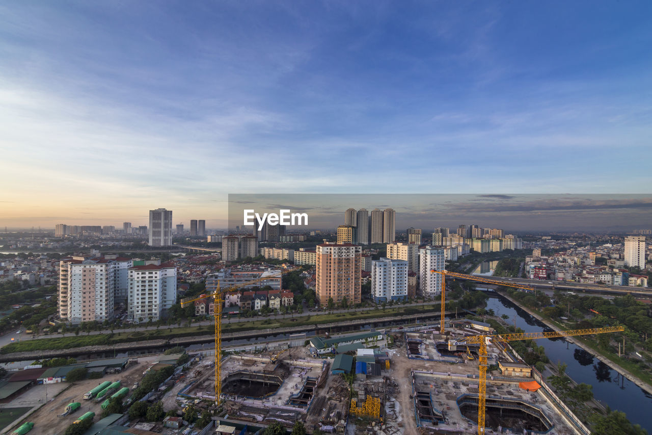 High angle view of road amidst buildings in city against sky