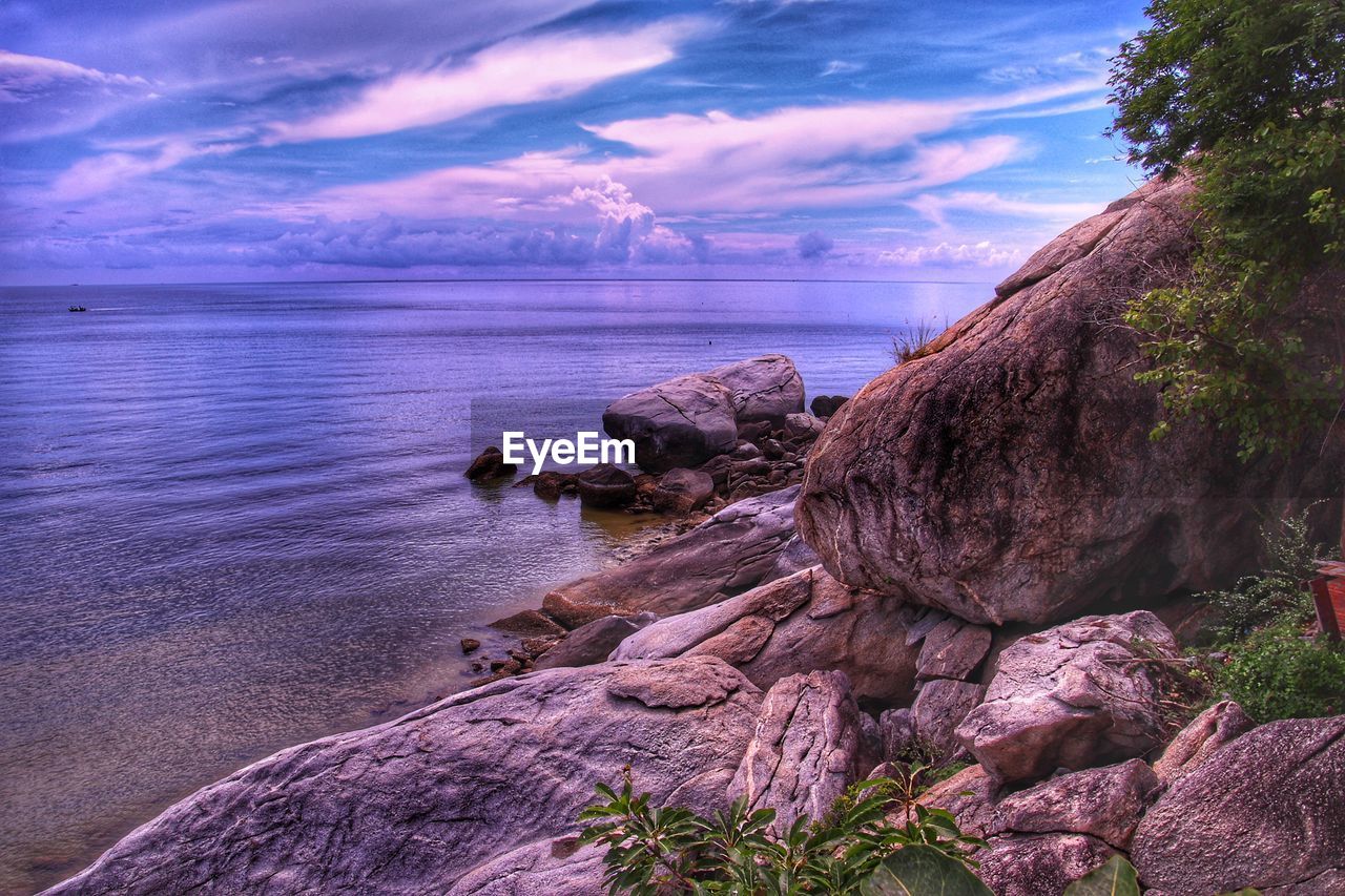 Scenic view of rock formation in sea against sky