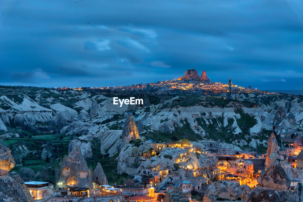 Aerial view of illuminated buildings against sky during winter