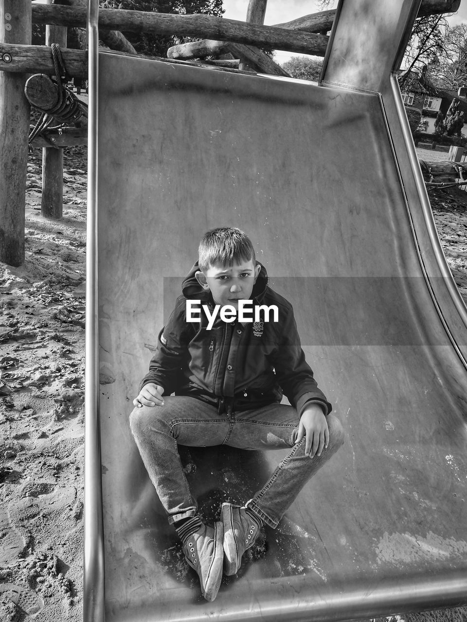 PORTRAIT OF BOY SITTING IN CONTAINER