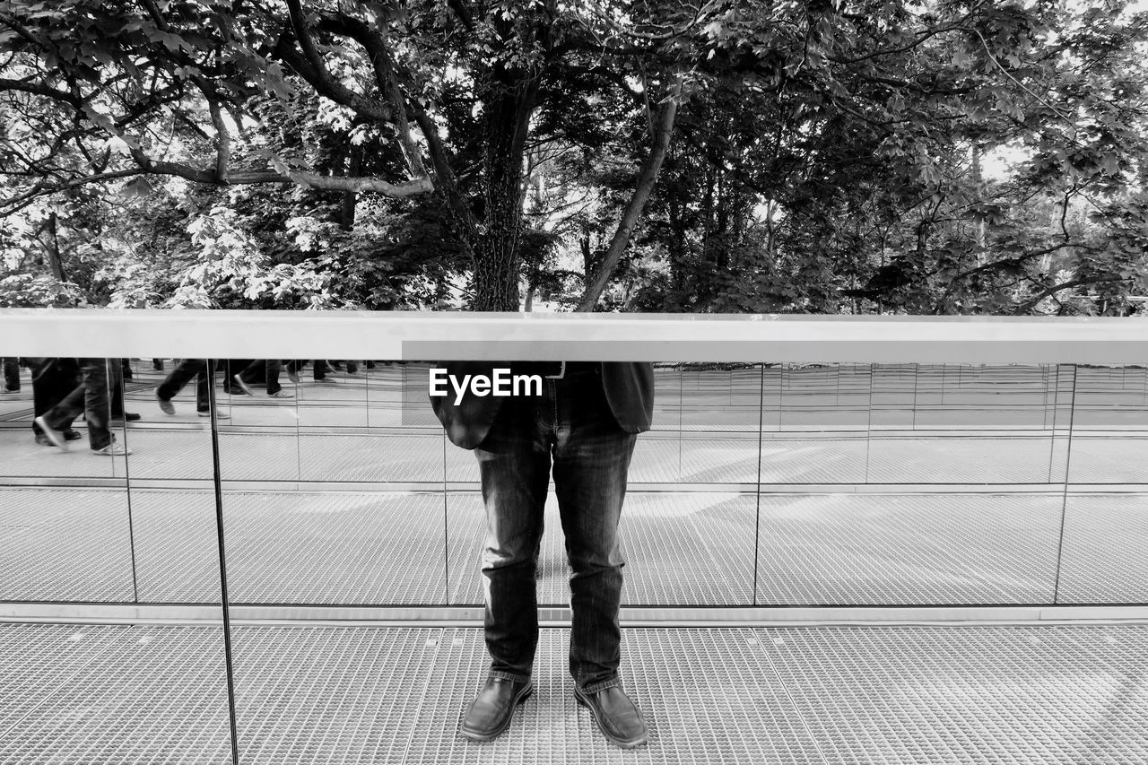 Man standing against tree