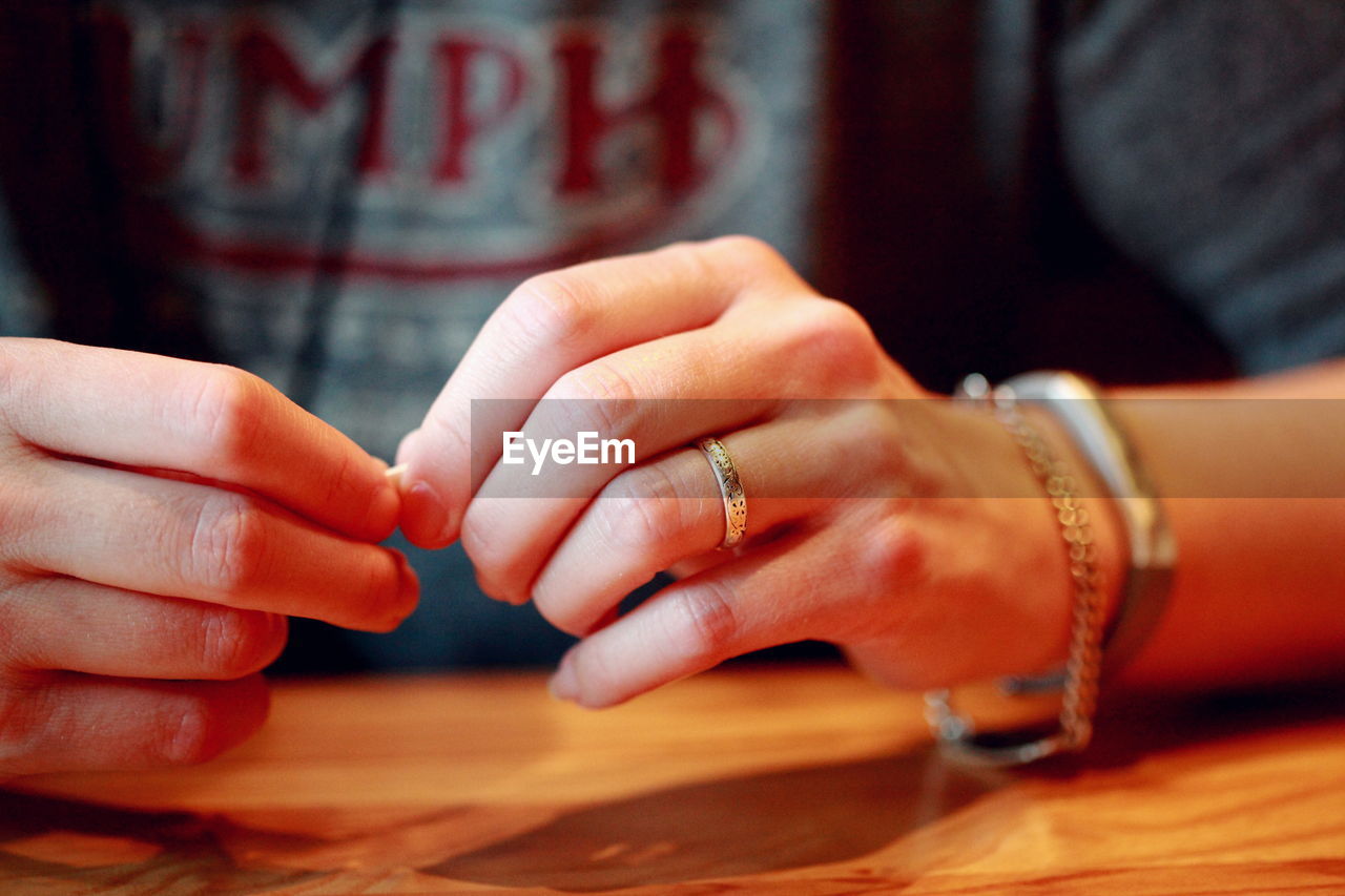 Midsection of woman at table