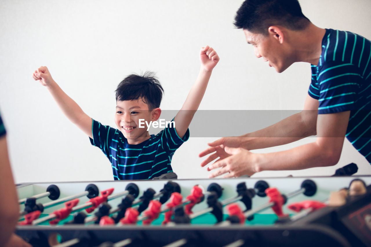 Family playing foosball at home