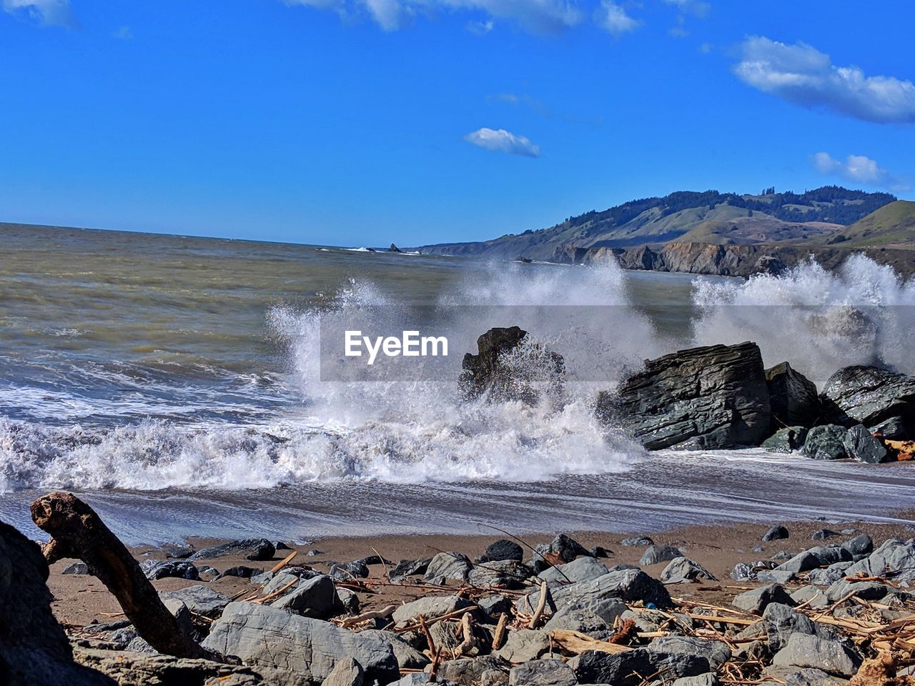 WAVES SPLASHING ON ROCKS AT BEACH