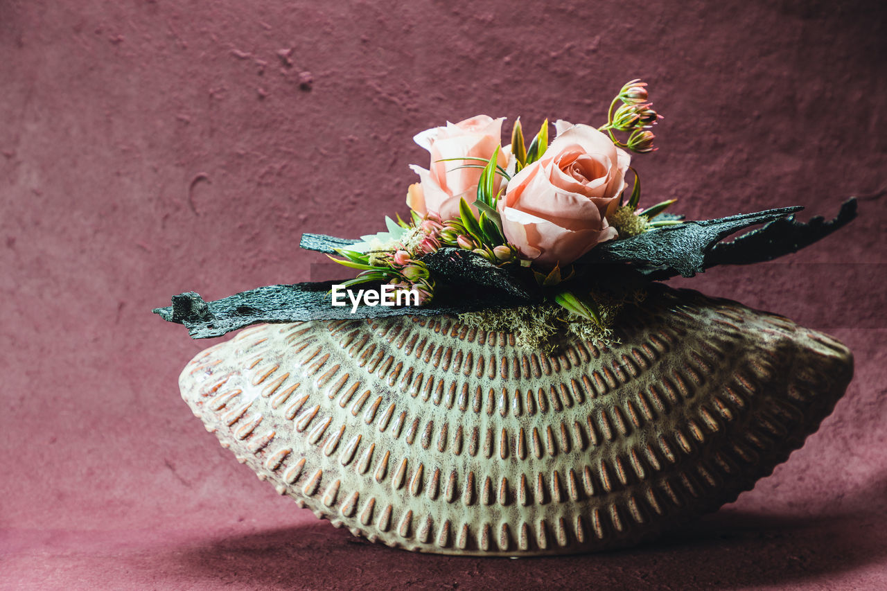 Elegan flower arrangement made out of silk, artificial flowers in a beautify, ceramic vase