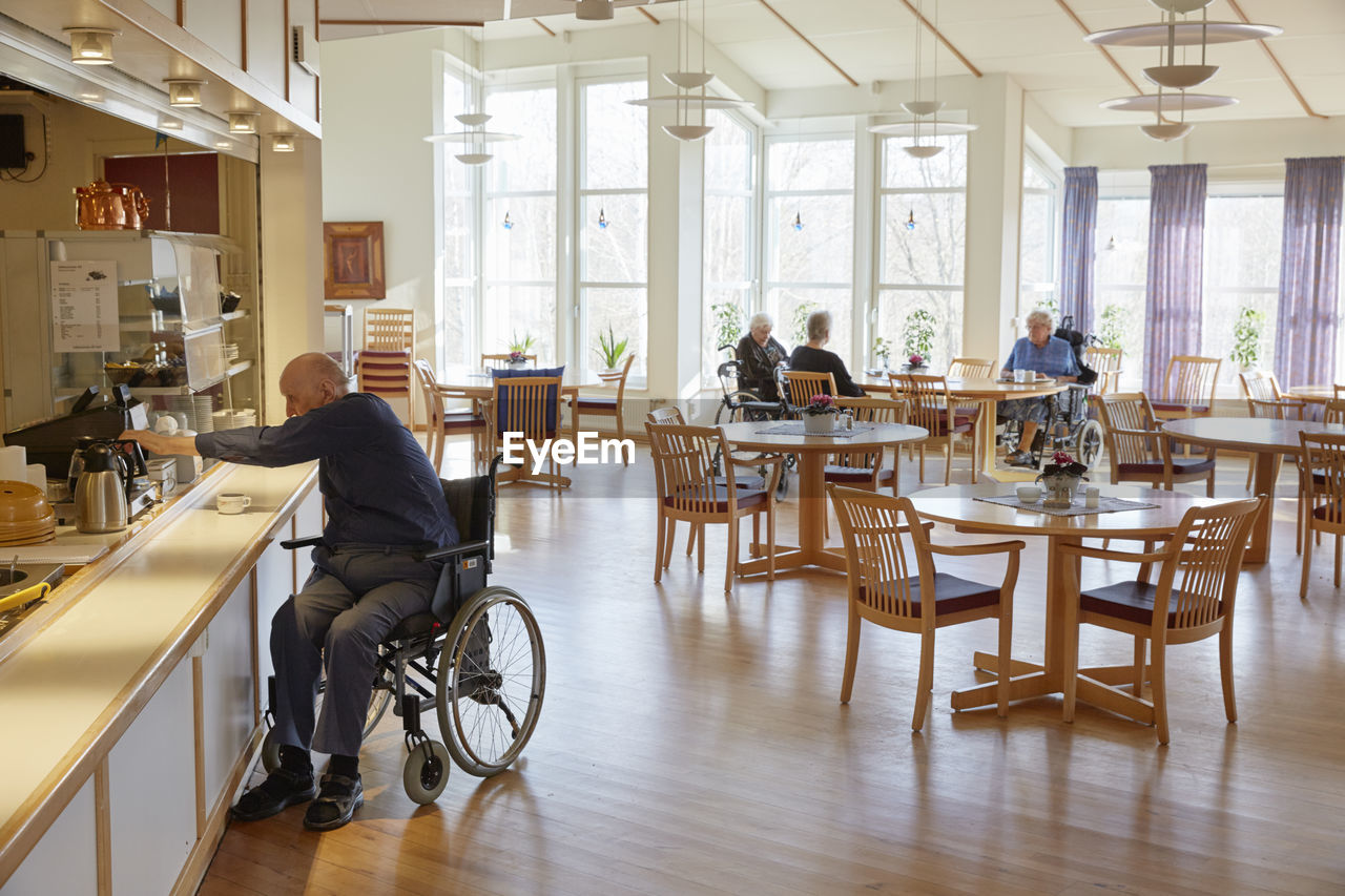 Senior man having coffee in dining room