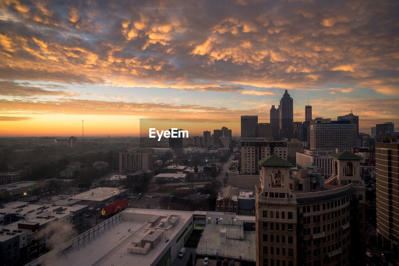 High angle view of buildings against sky during sunset