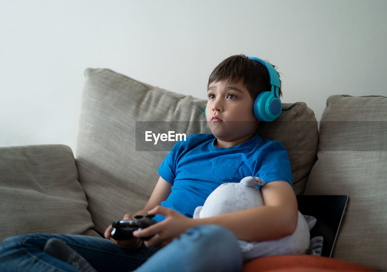 Boy playing video game at home