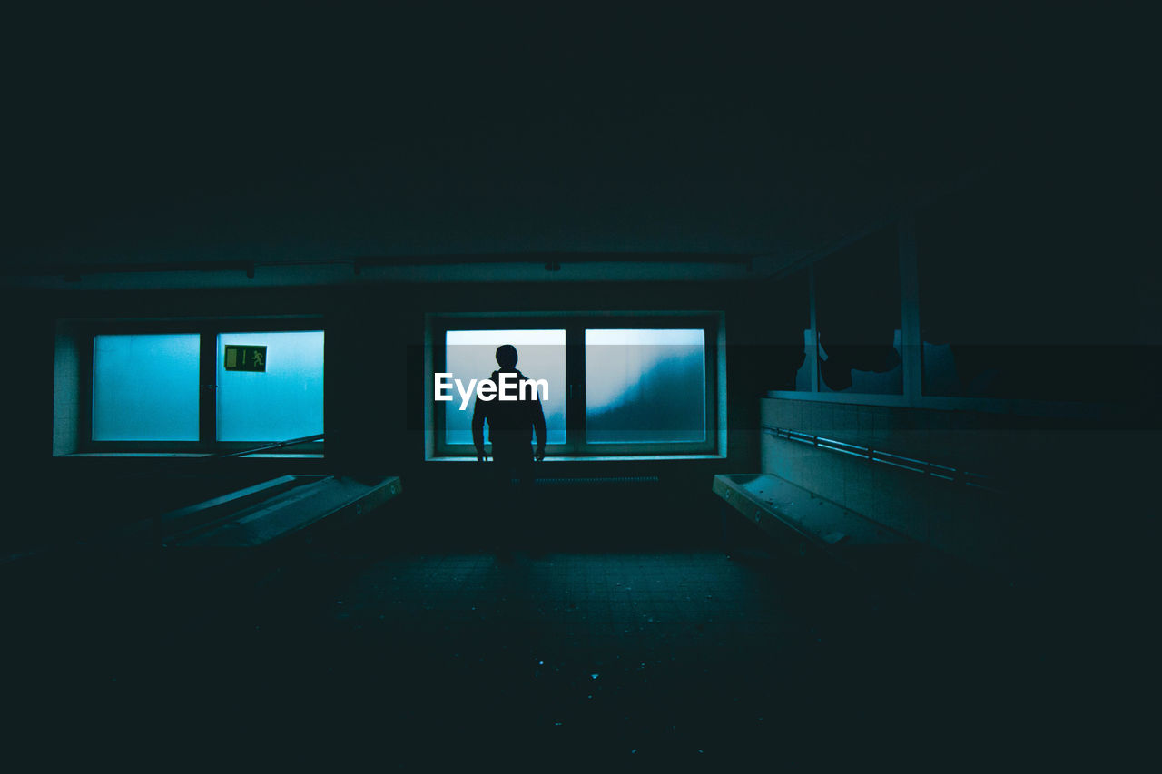 SILHOUETTE MAN IN ILLUMINATED TUNNEL