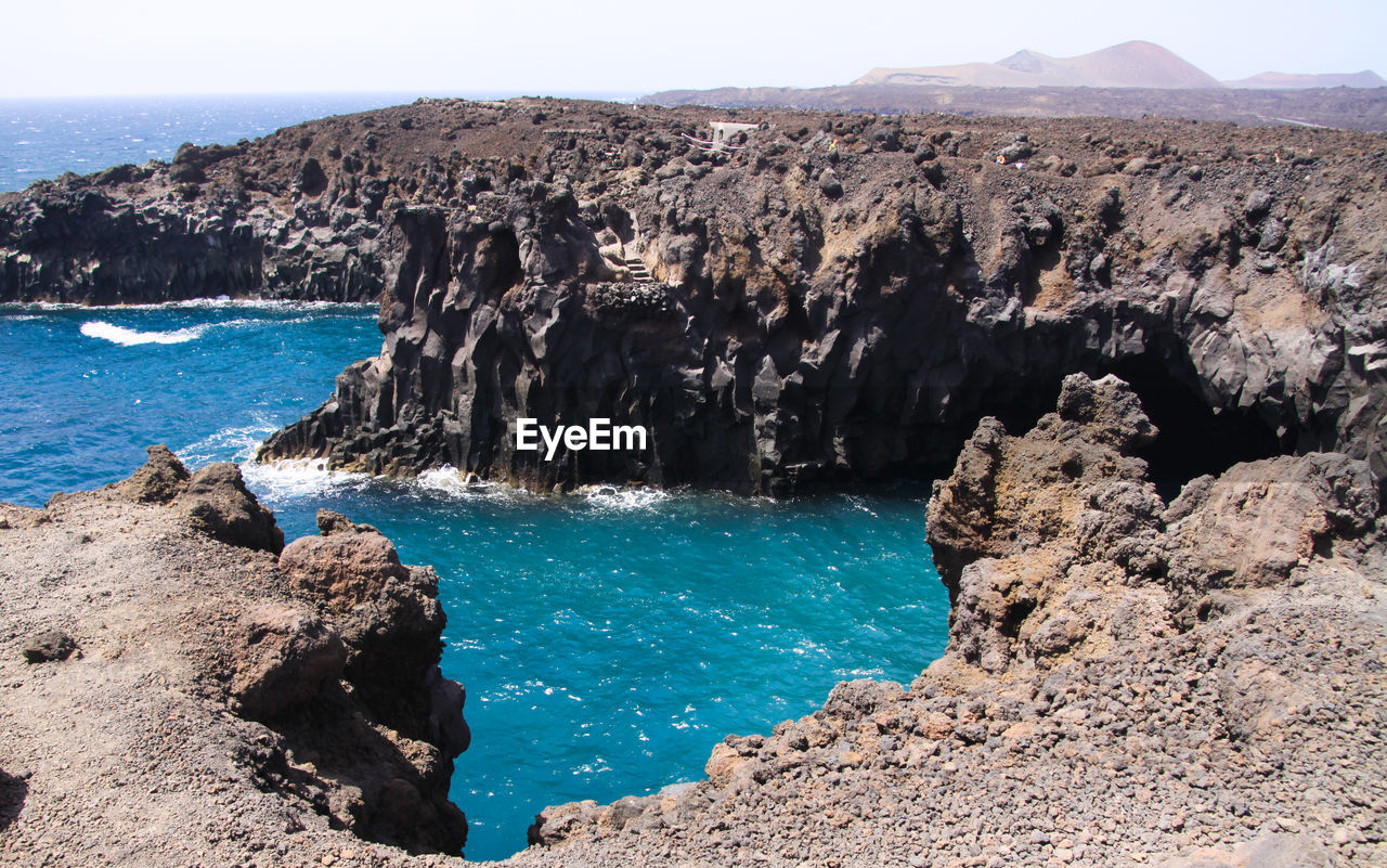 Panoramic view of sea and rocks against sky