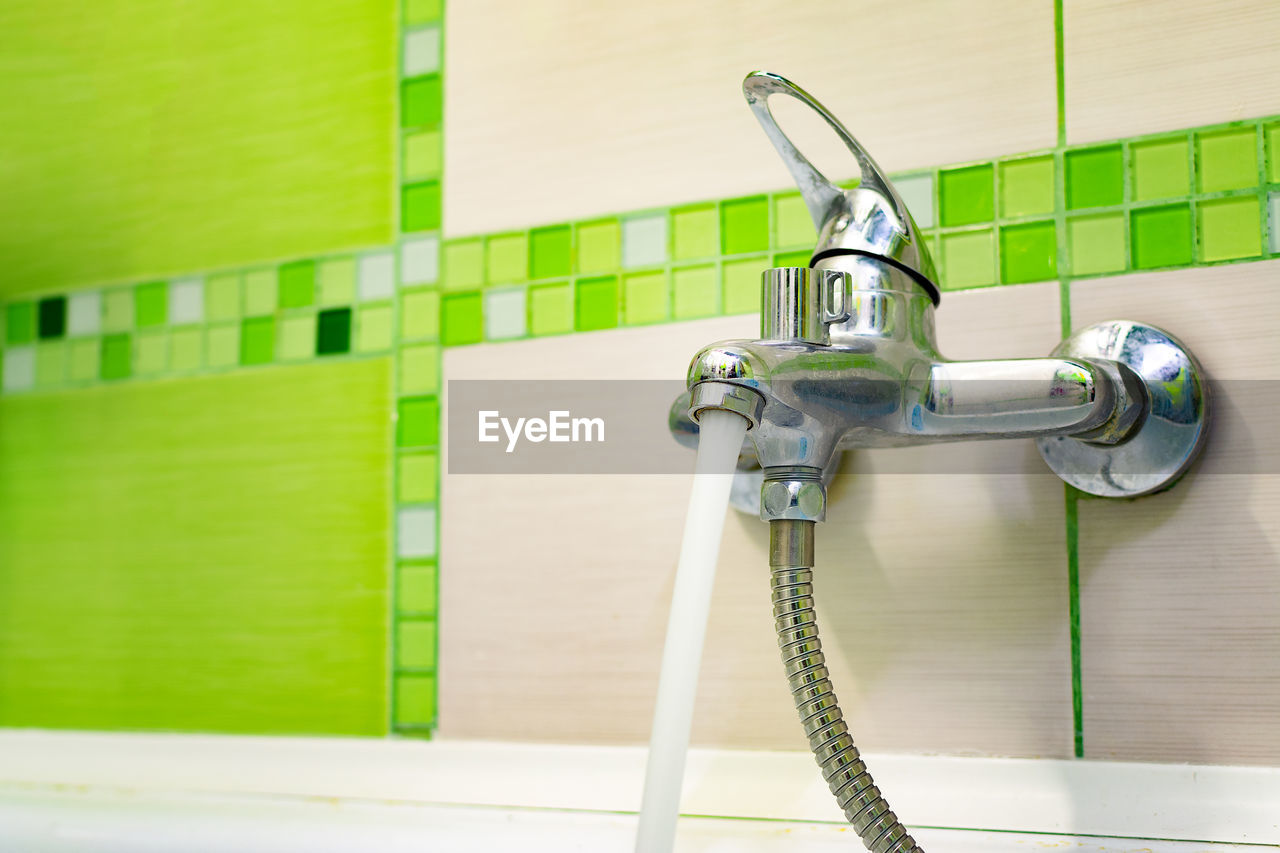 Close-up of running water from faucet in bathroom