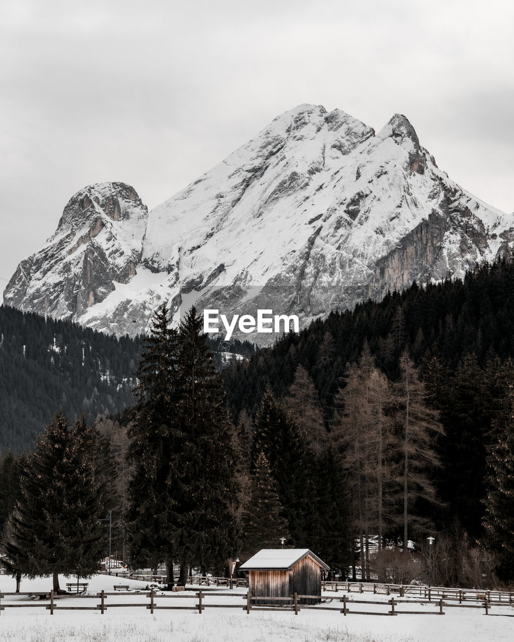 Hut against snowcapped mountain