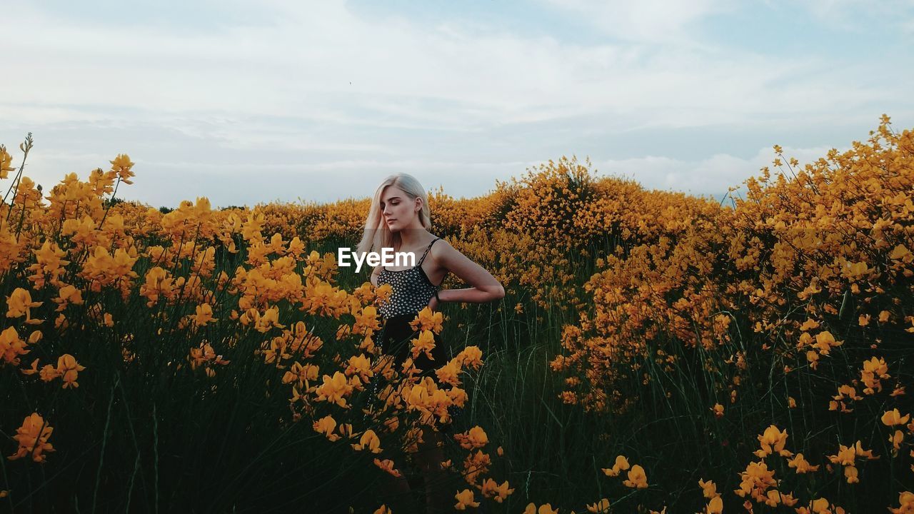 Young woman standing on field at farm