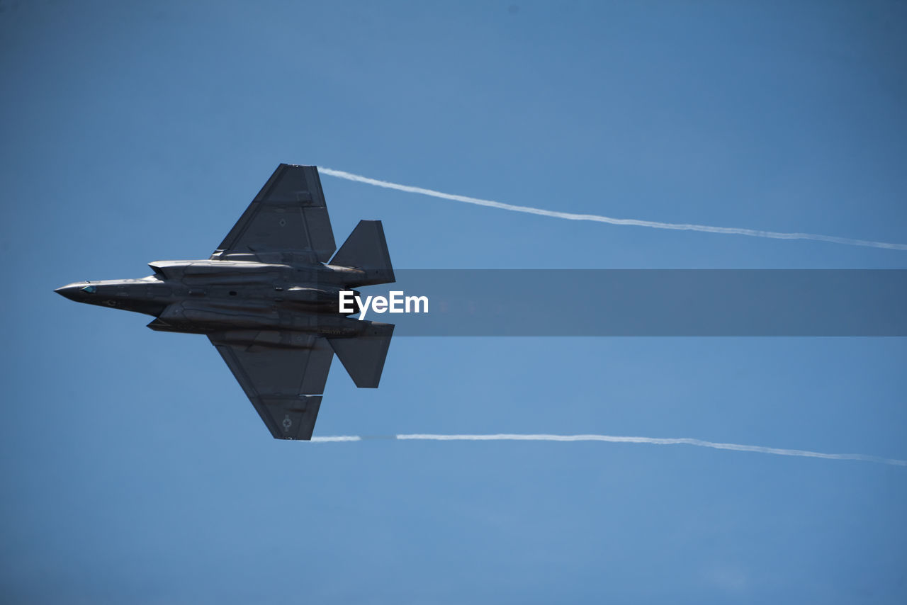 LOW ANGLE VIEW OF AIRPLANE FLYING IN SKY